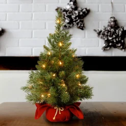New National Tree Company Pre-Lit Artificial Christmas Tree, Majestic Fir, Green, White Lights, Includes Red Cloth Base, 2 Feet